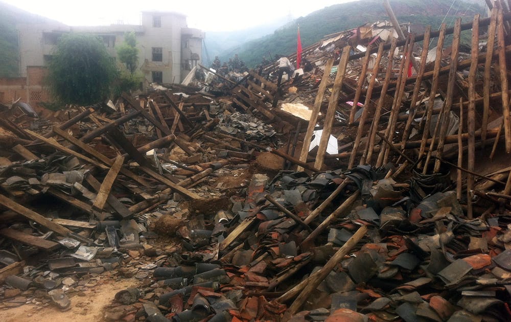 Rescue workers search for survivors in the epicenter of an earthquake that struck the town of Longtoushan in Ludian county in southwest China`s Yunnan province.
