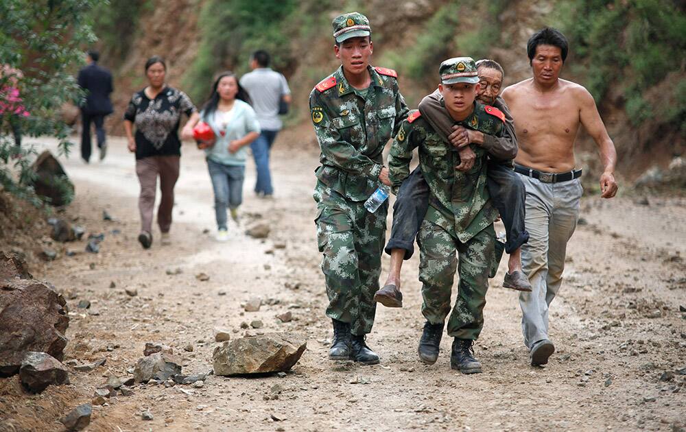 Rescuers transport an injured man after an earthquake in Ludian County of Zhaotong City in southwest China`s Yunnan Province.