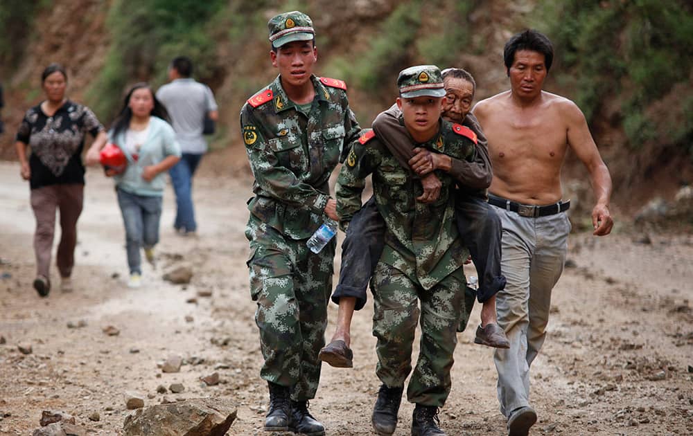 Rescuers transport injured people after an earthquake in Zhaotong City in the densely populated Ludian county in southwest China`s Yunnan Province.