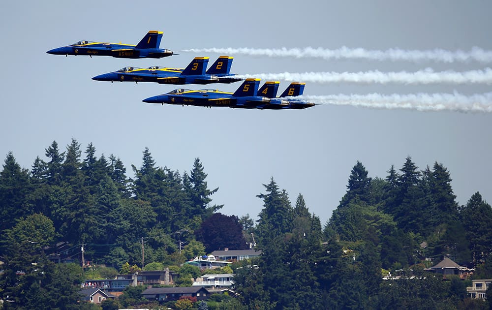 The US Navy Blue Angels fly over homes near Lake Washington during the Seafair Air Show, in Seattle.