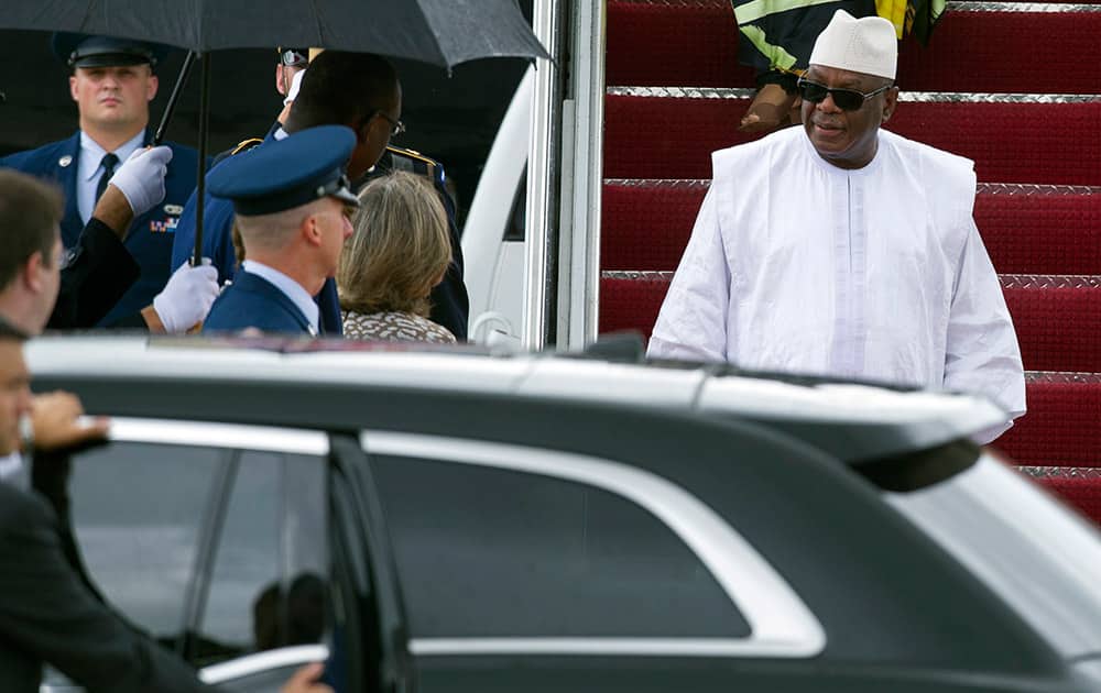 Mali President Ibrahim Boubacar Keita, right, arrives at Andrews Air Force Base, Md., to attend the US - Africa Leaders Summit.
