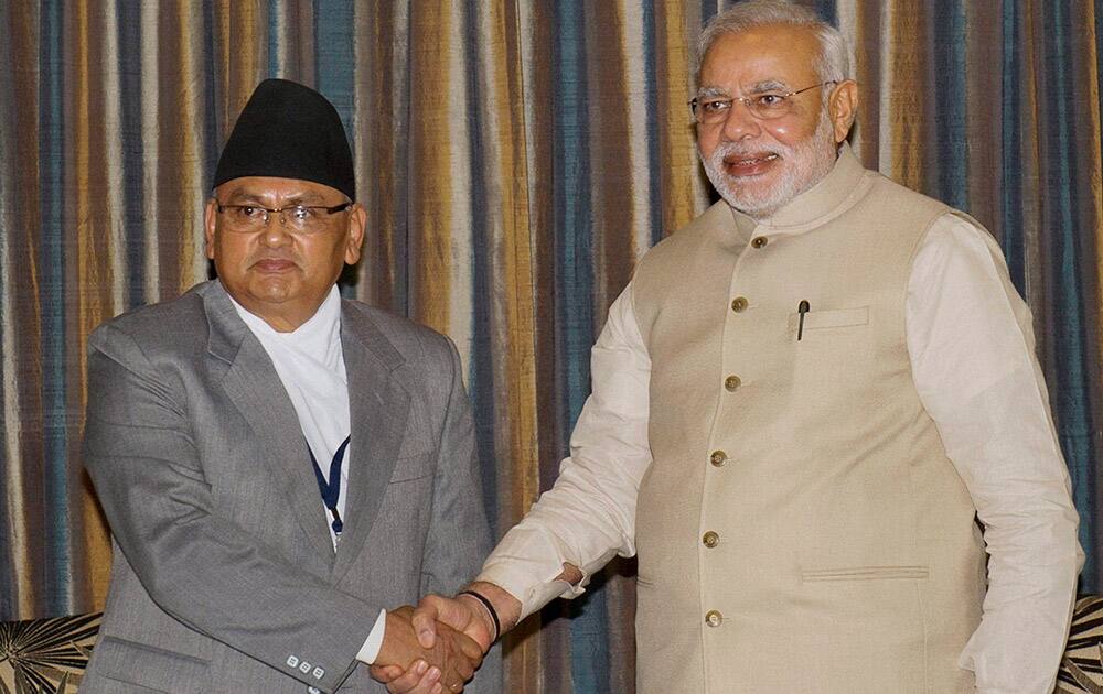 Prime Minister Narendra Modi shakes hands with Nepalese Foreign Minister Mahendra Bahadur Pandey during a meeting in Kathmandu, Nepal.