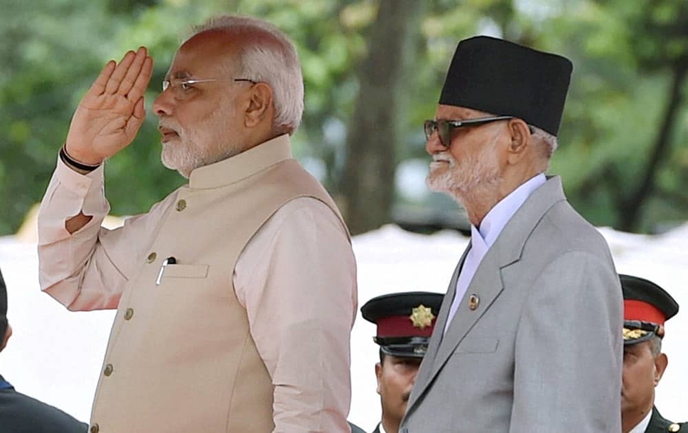 Prime Minister Narendra Modi during the official Welcome ceremony seen with his Nepalese counterpart Sushil Koirala (L) on arrival at VVIP lounge compound of Tribhuvan International Airport in Kathmandu, Nepal.