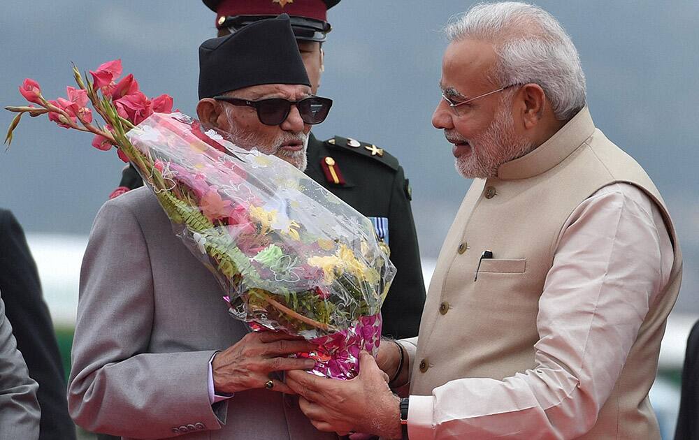 Prime Minister Narendra Modi being welcomed by his Nepalese counterpart Sushil Koirala on arrival at Tribhuvan International Airport in Kathmandu, Nepal.