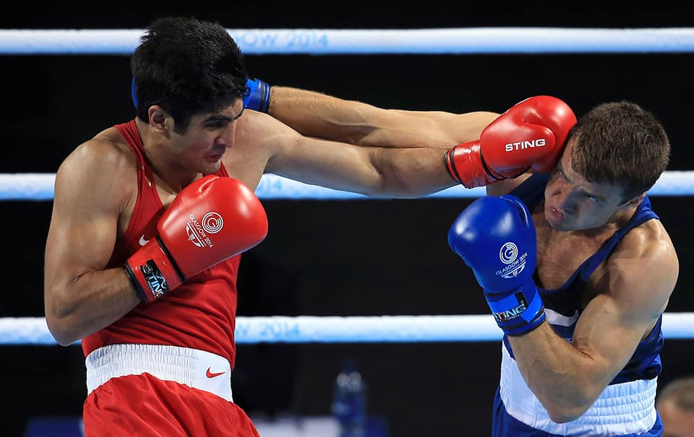 England`s Antony Fowler, right, and India`s Vijender Vijender fight in the men`s middleweight 75kg final during the 2014 Commonwealth Games in Glasgow, Scotland.