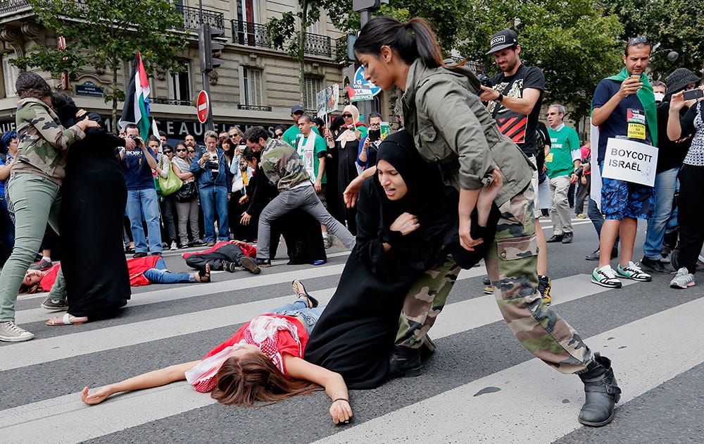 Demonstrators stage a scene during a demonstration against Israel`s military operations in Gaza and in support of the Palestinian people in Paris.