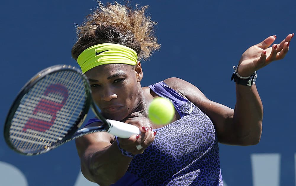 Serena Williams, of the United States, returns the ball to Andrea Petkovic, from Germany, during the second set of a semifinal in the Bank of the West Classic tennis tournament in Stanford, Calif.
