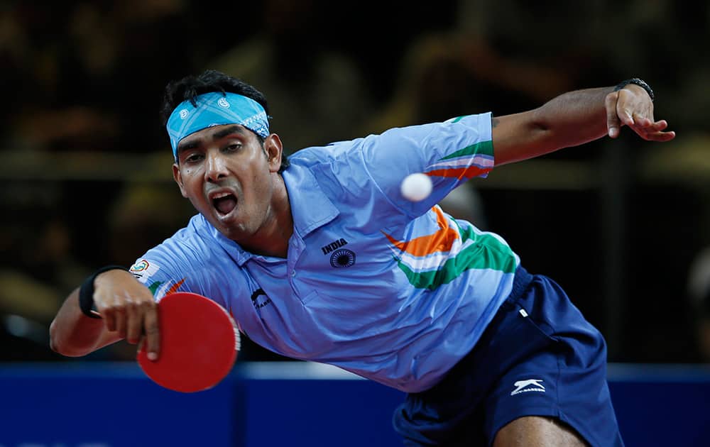 Sharath Kamal Achanta of India plays a return to Jian Zhan of Singapore during their men`s singles table tennis semifinal match the Scotstoun centre at the Commonwealth Games Glasgow 2014, in Glasgow.