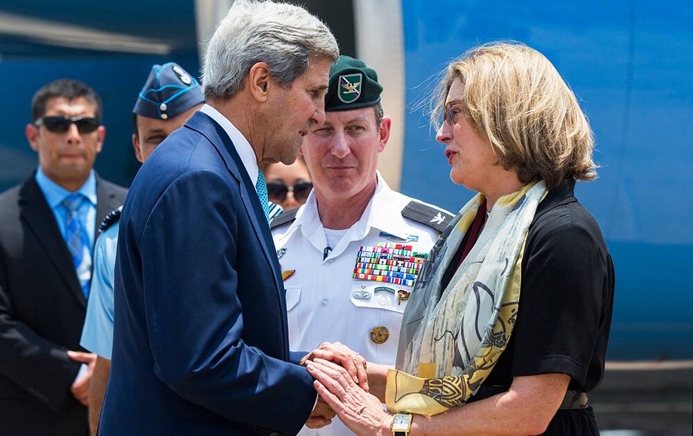US Secretary of State John Kerry speaks with US Embassy Chargé d`Affaires Kathleen Stephens before boarding an aircraft to depart New Delhi.