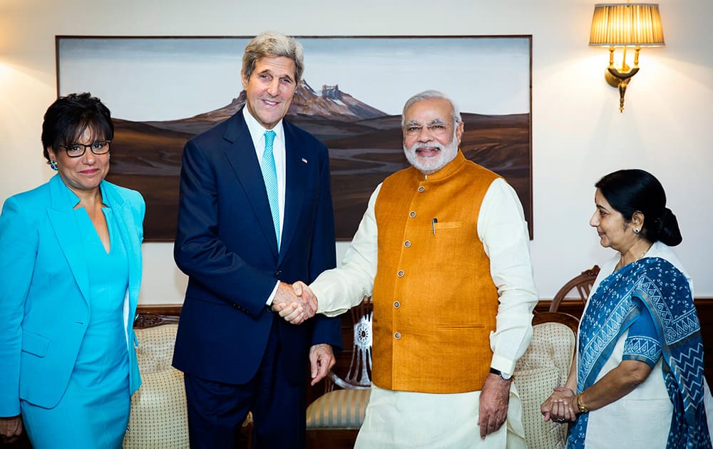 US Secretary of State John Kerry shakes hands with Indian Prime Minister Narendra Modi, as Indian Foreign Minister Sushma Swaraj and US Secretary of Commerce Penny Pritzker stand by their sides at Modi`s residence in New Delhi.