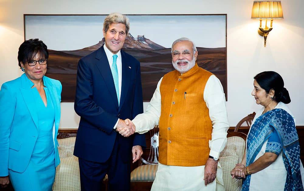US Secretary of State John Kerry shakes hands with Indian Prime Minister Narendra Modi, as Indian Foreign Minister Sushma Swaraj and US Secretary of Commerce Penny Pritzker stand by their sides at Modi`s residence in New Delhi.