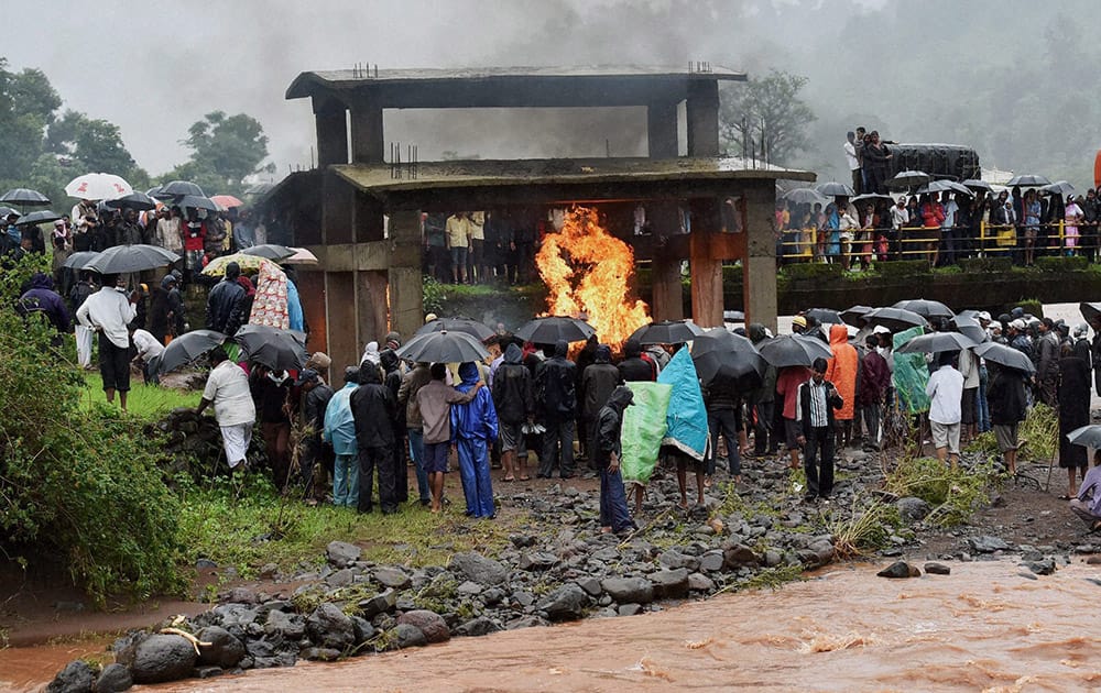 Mass funeral of the victims near the site of a landslide in Malin village in Pune, Maharashtra on Thursday. Torrential rains triggered a massive landslide that buried a remote village.
