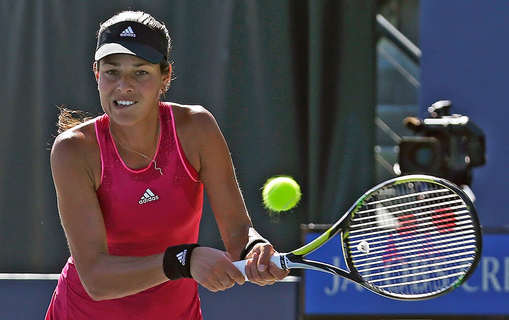 Ana Ivanovic, of Serbia, returns the ball during the second set of her match against Carol Zhao in the Bank of the West Classic tennis tournament in Stanford, Calif.