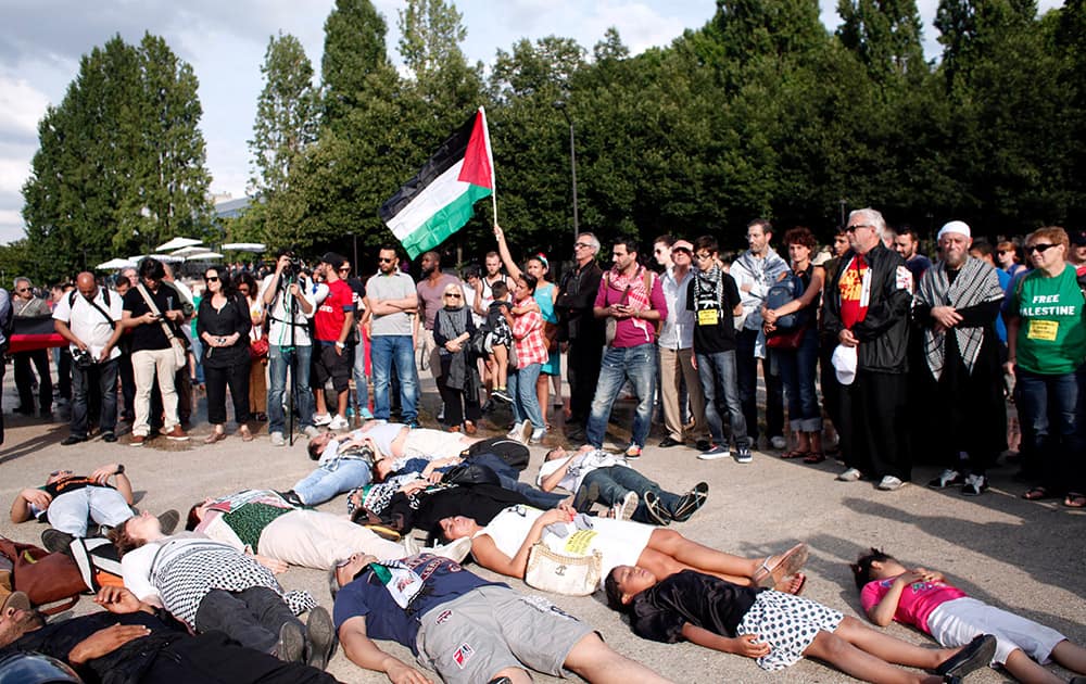 People lay on the ground as they protest against Israel`s military operations in Gaza and in support of the Palestinian people, in Paris.
