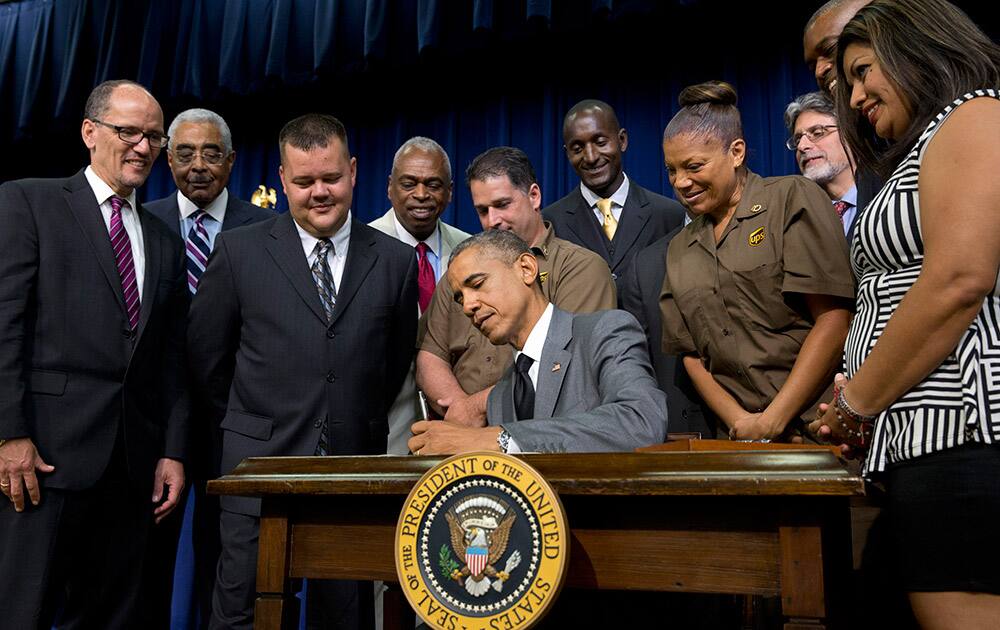 President Barack Obama signs the `Fair Pay and Safe Workplace` executive order, requiring prospective federal contractors to disclose labor law violations, in the South Court Auditorium of the Eisenhower Executive Office Building on the White House complex in Washington.