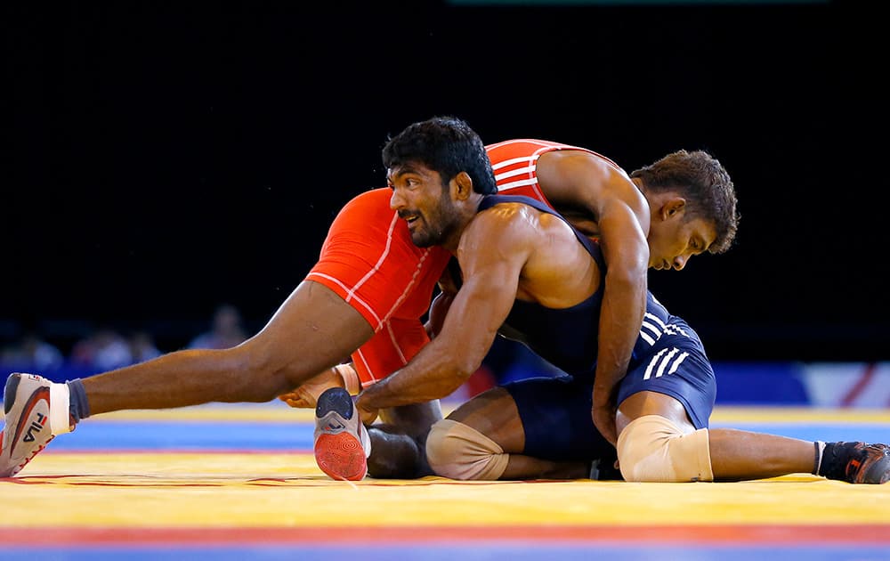 Yogeshwar Dutt of India wrestles with Chamara Perera of Sri Lanka during a men`s FS 65kg semifinal wrestling bout at the Scottish Exhibition Conference Centre during the Commonwealth Games 2014 in Glasgow, Scotland.