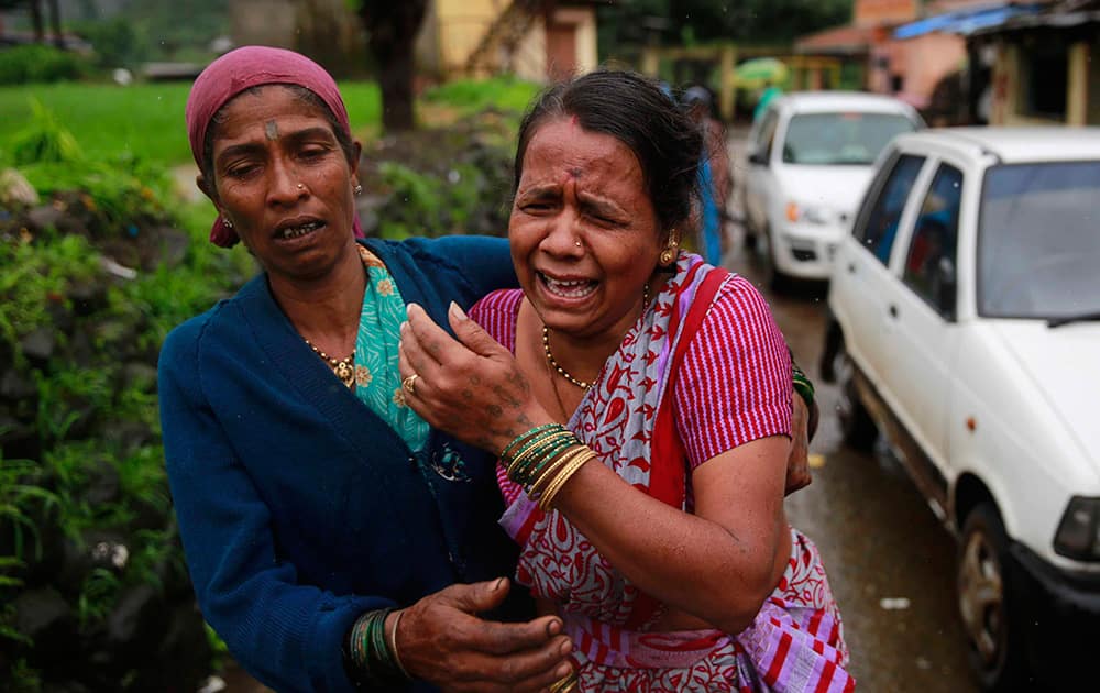 Women wail after seeing the body of a relative, victim of a landslide, in Malin village in Pune district of the western Indian state of Maharashtra.