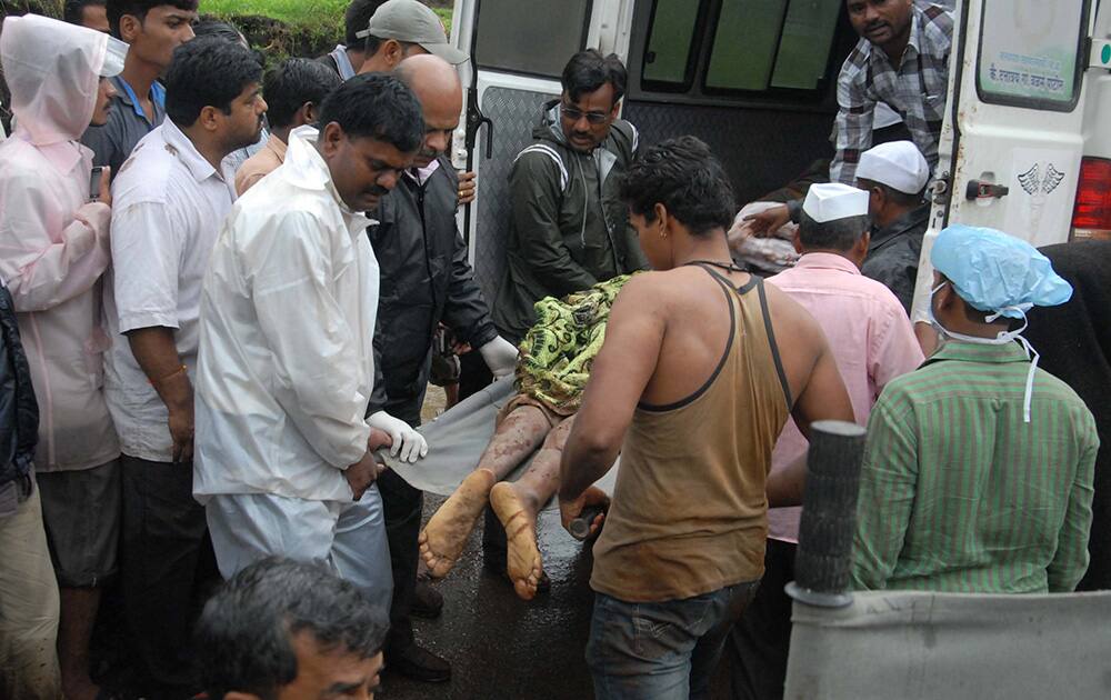 The body of a landslide victim is unloaded from an ambulance outside a hospital in Ghodegaon village, some 35 kilometers (22 miles) from Malin village, in the western Indian state of Maharashtra.