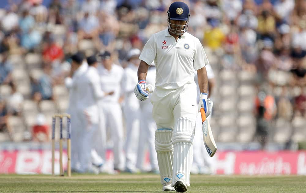 India`s captain and wicketkeeper Mahendra Singh Dhoni walks off the field of play after losing his wicket off the bowling of England`s James Anderson during the fifth and final day of the third cricket Test match of the series between England and India at The Ageas Bowl in Southampton, England.
