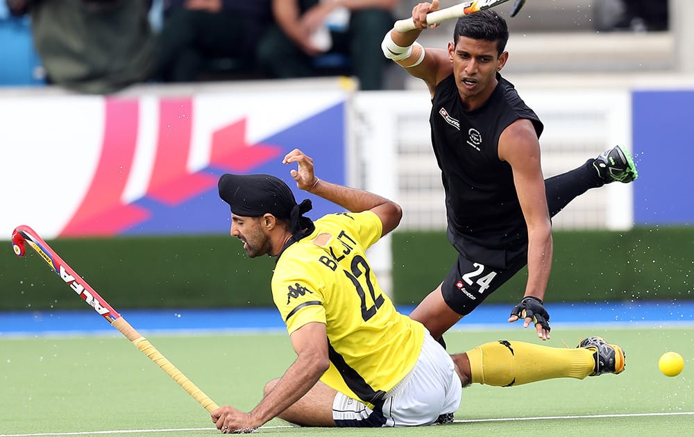 New Zealand`s Arun Panchia vies for the ball with Mayalsia`s Bajiit Charun Singh during their men`s field hockey match at the Commonwealth Games Glasgow 2014, at the National Hockey Centre, Glasgow, Scotland.