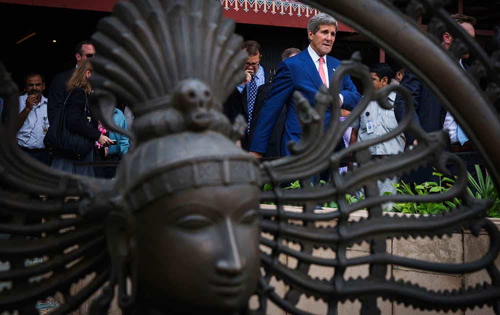 US Secretary of State, John Kerry, walks past a statue after a visit to the Central Cottage Industries Emporium in New Delhi.
