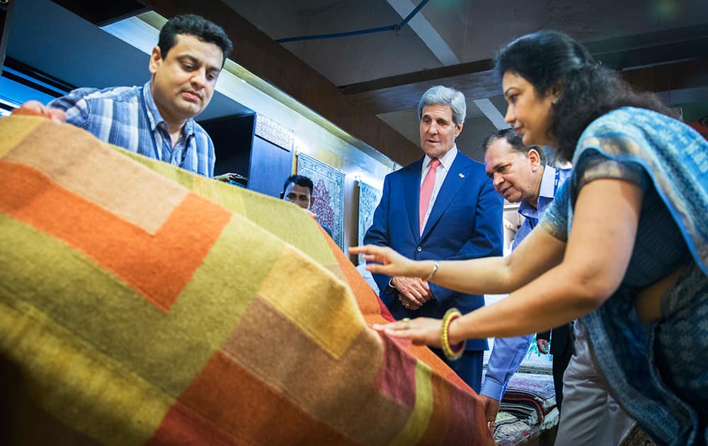 US Secretary of State, John Kerry, looks at carpets during a visit to the Central Cottage Industries Emporium in New Delhi.