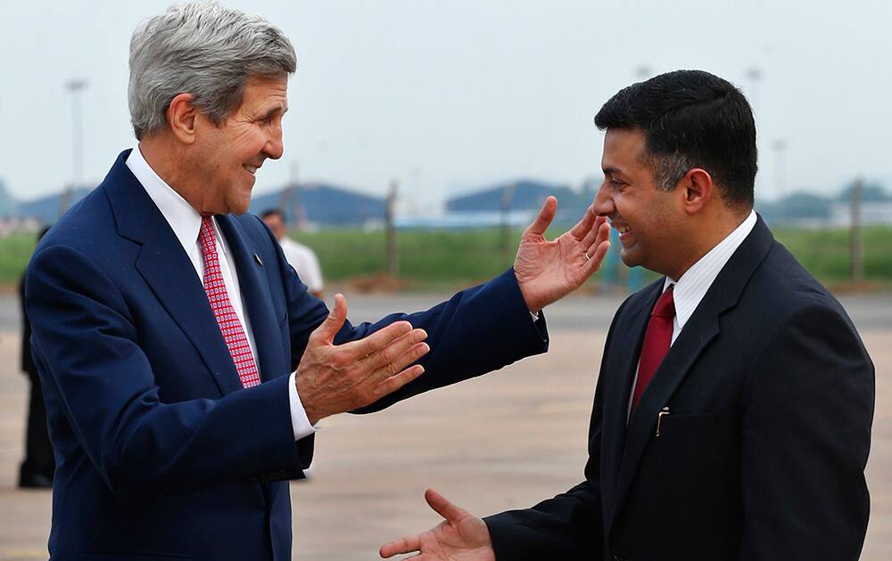 US Secretary of State John Kerry greets Indian Joint Secretary (Americas) Vikram Kumar Doraiswami upon arrival at the airport in New Delhi.