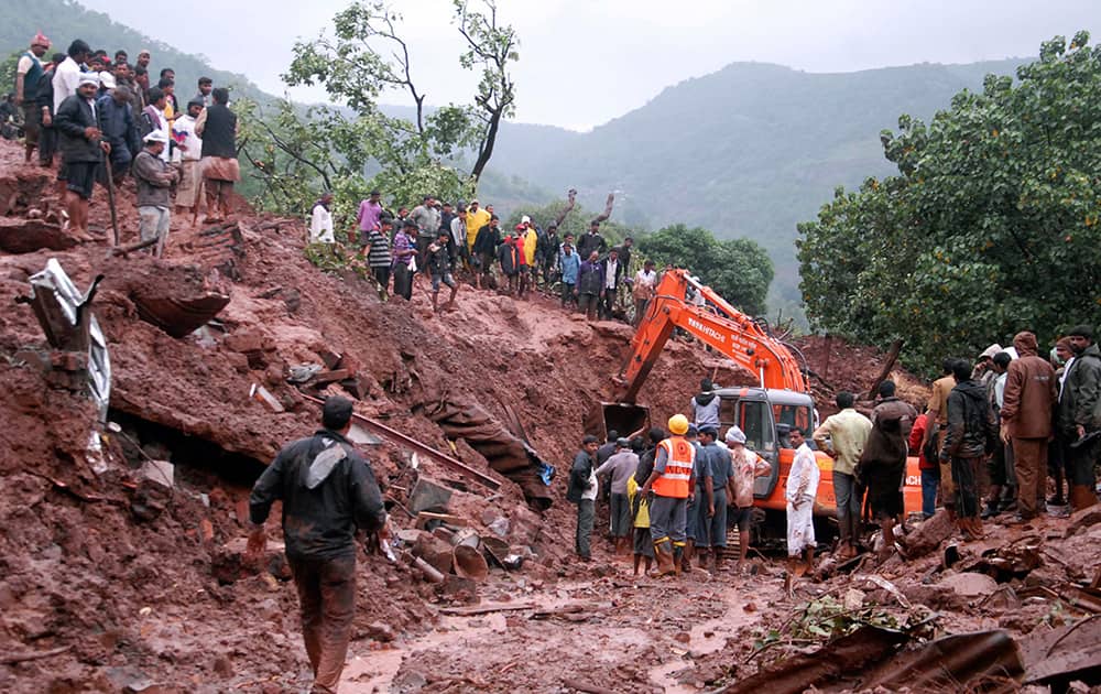 Rescuers work at the site of a landslide in Malin village, in the western Indian state of Maharashtra.