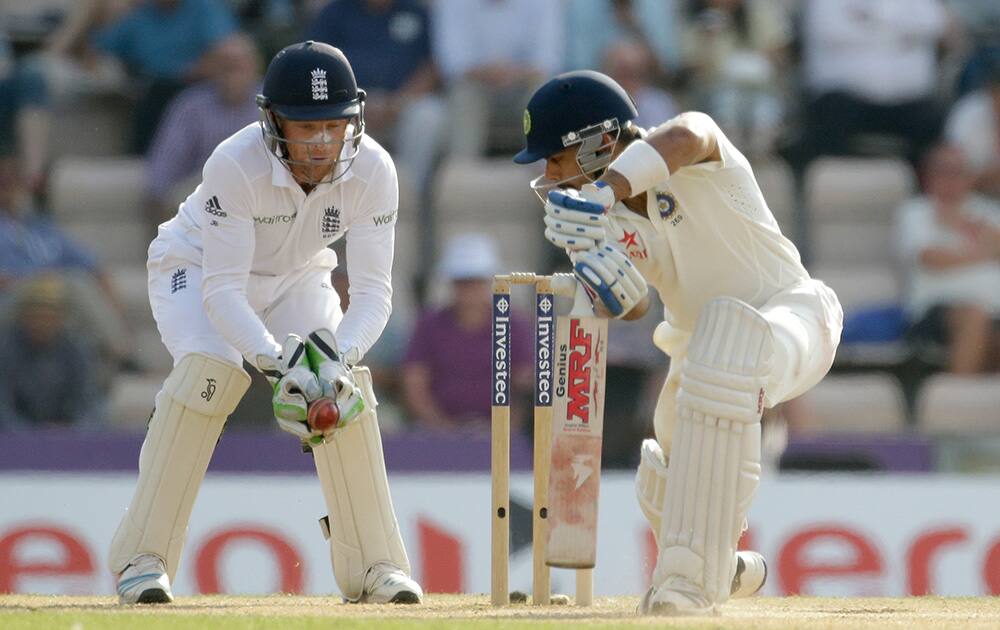 India`s Virat Kohli, right, is caught out by test debutant England wicketkeeper Jos Buttler off a Moeen Ali delivery during the fourth day of the third cricket test match of the series between England and India at The Ageas Bowl in Southampton, England.