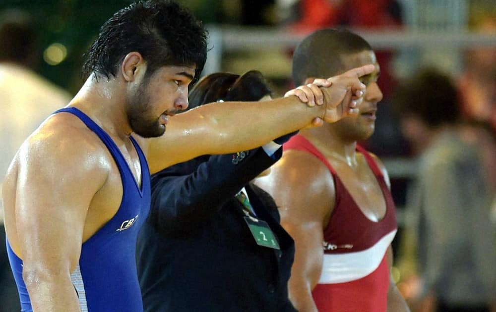 India`s Satywart Kadian is declared winner against England`s Leon Rattigan in the semifinal match of Men`s Freestyle Wrestling 97 kg event during the Commonwealth Games 2014 in Glasgow, Scotland.
