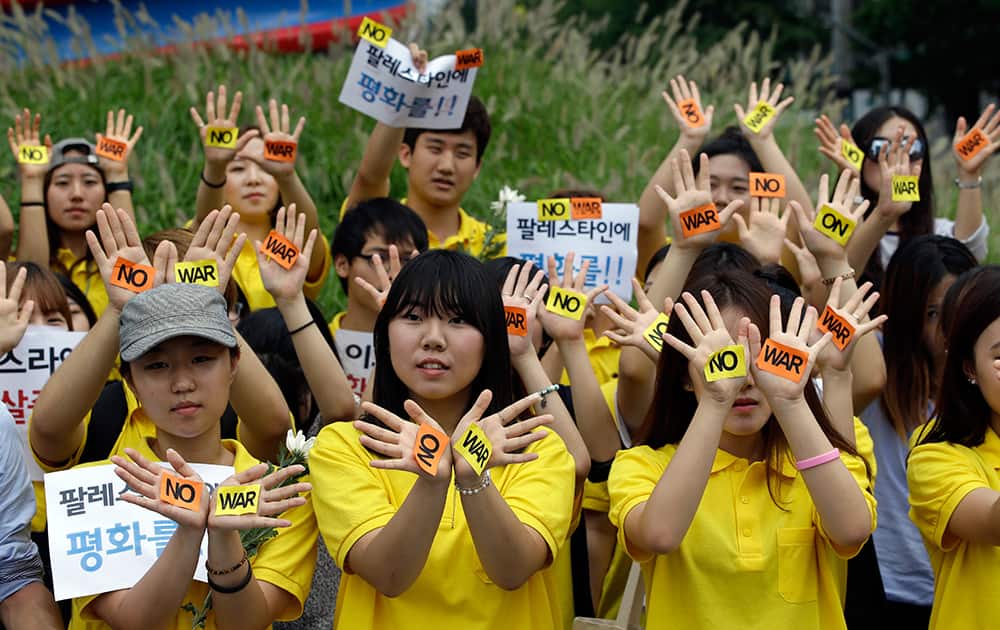 South Korean students hold a rally against the Israeli military operations in Gaza and the West Bank and wish for peace near the Israeli Embassy in Seoul, South Korea.