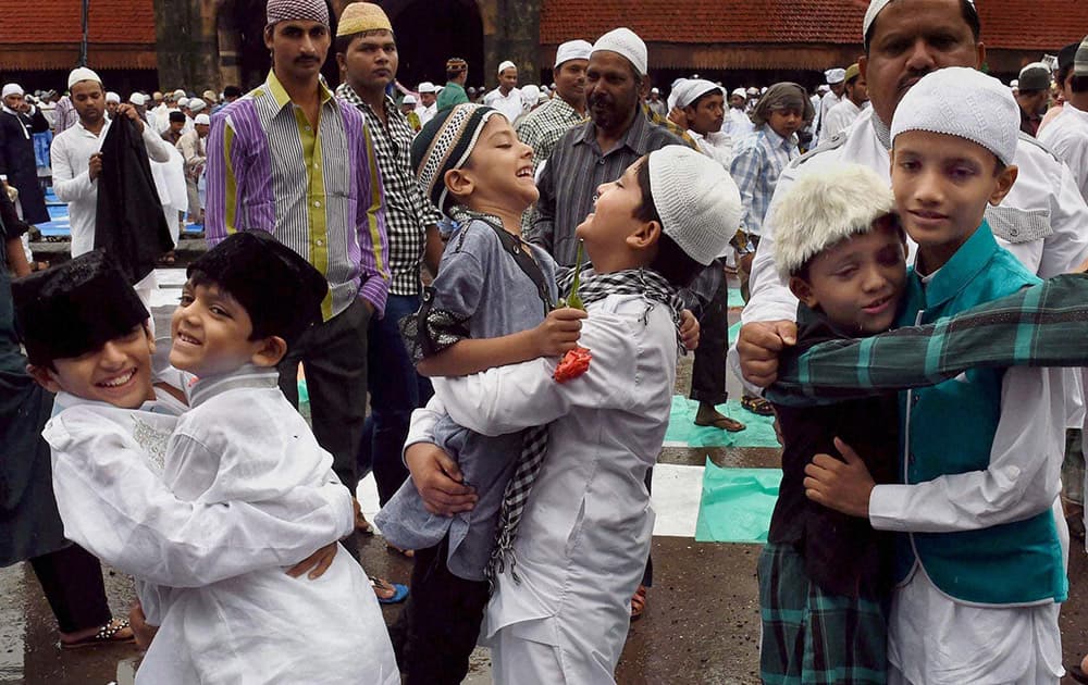 Muslim children greet each other after offering prayers on the occasion of `Eid-Ul-Fitr` in Mumbai.