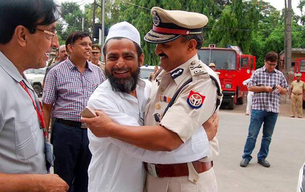 A police officer greets a Muslim man on the occasion of Eid-al-Fitr in riot-hit Saharanpur where curfew was relaxed for some hours.