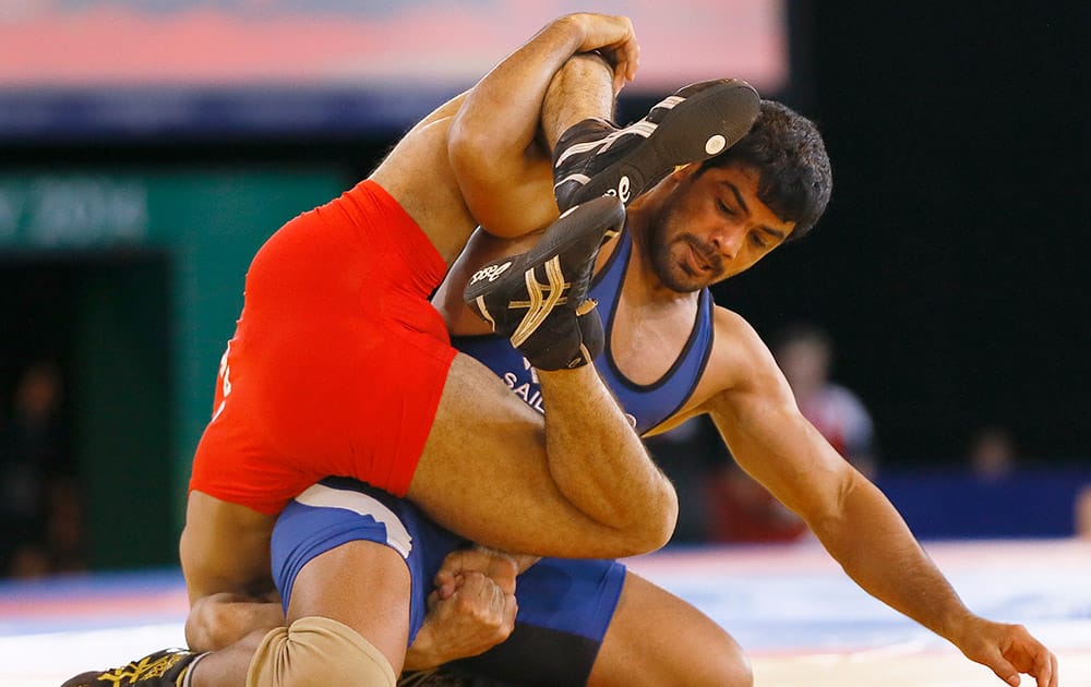 Sushil Kumar of India, right, wrestles with Qamar Abbas of Pakistan in a FS 74kg gold medal wrestling match at the Scottish Exhibition Conference Centre during the Commonwealth Games 2014 in Glasgow.