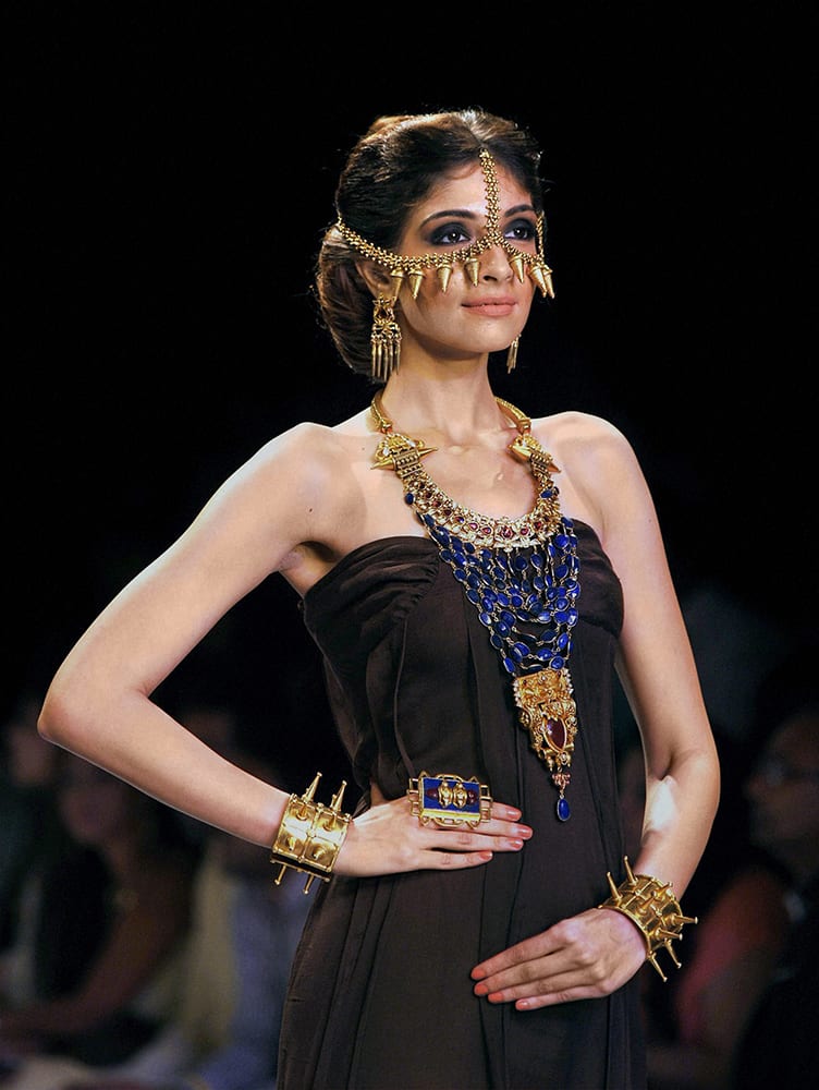 A model walks the ramp during the India International Jewellery Week (IIJW) in Mumbai.