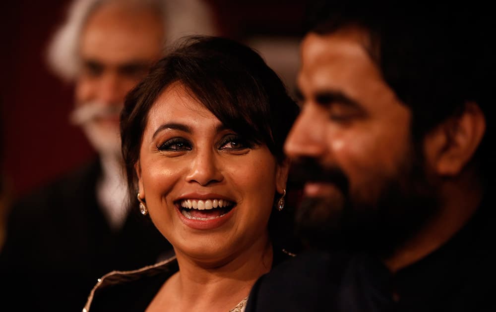 Actress Rani Mukherji smiles as she praises the work of designer Sabyasachi, right, at the India Couture Week, held by Fashion Design Council of India, in New Delhi.