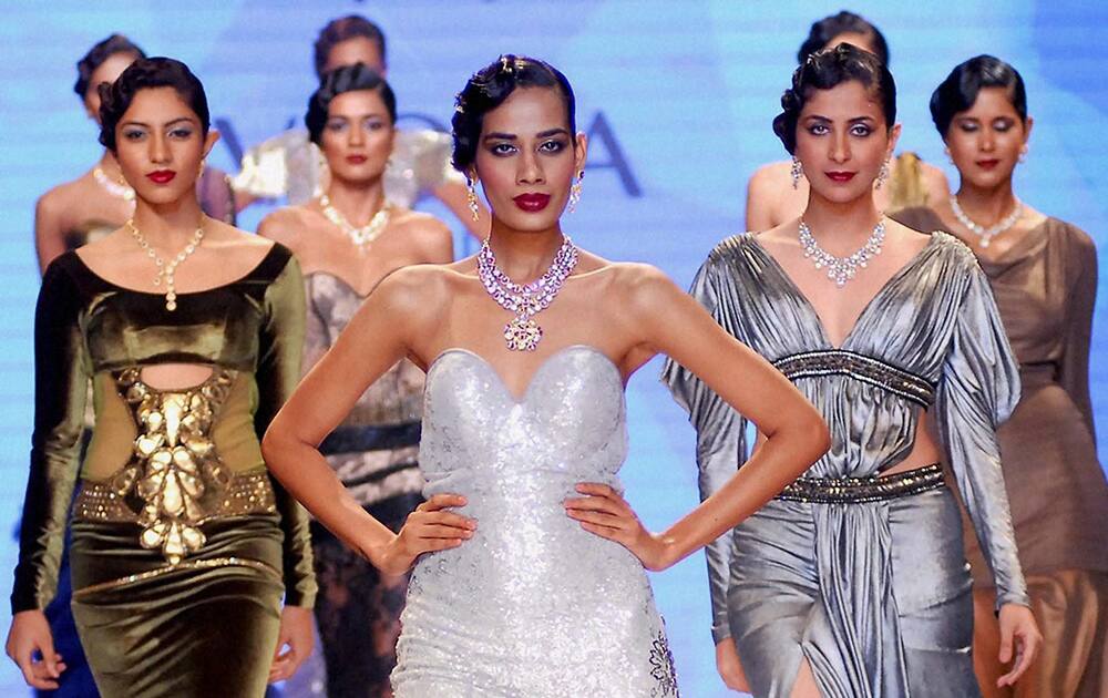 Models display jewellery creations during the India International Jewellery Week (IIJW) in Mumbai on Tuesday evening.