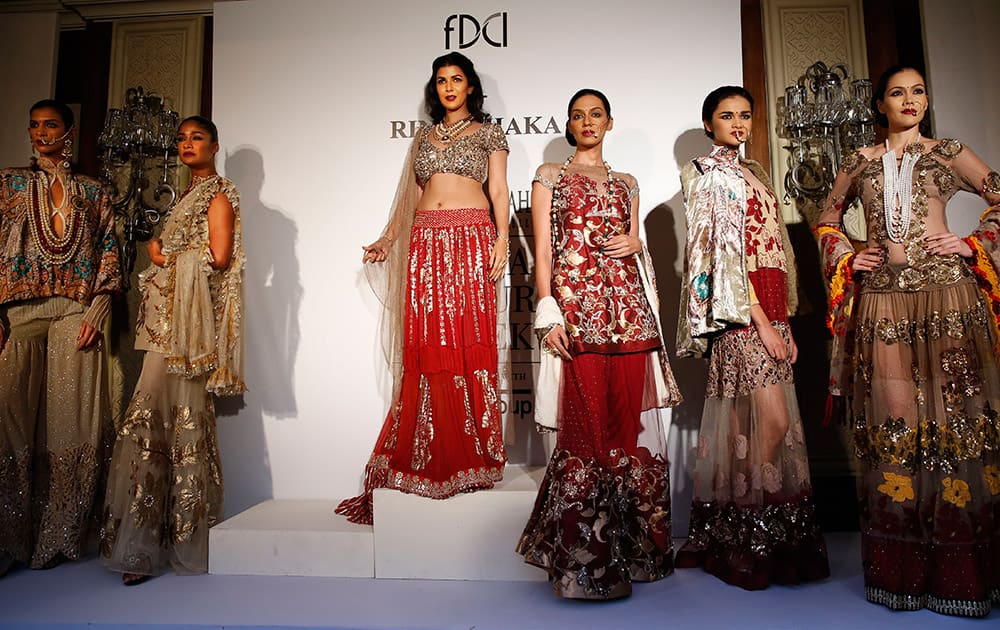 Models display dresses created by Indian designer Rina Dhaka at the India Couture Week, held by Fashion Design Council of India, in New Delhi.