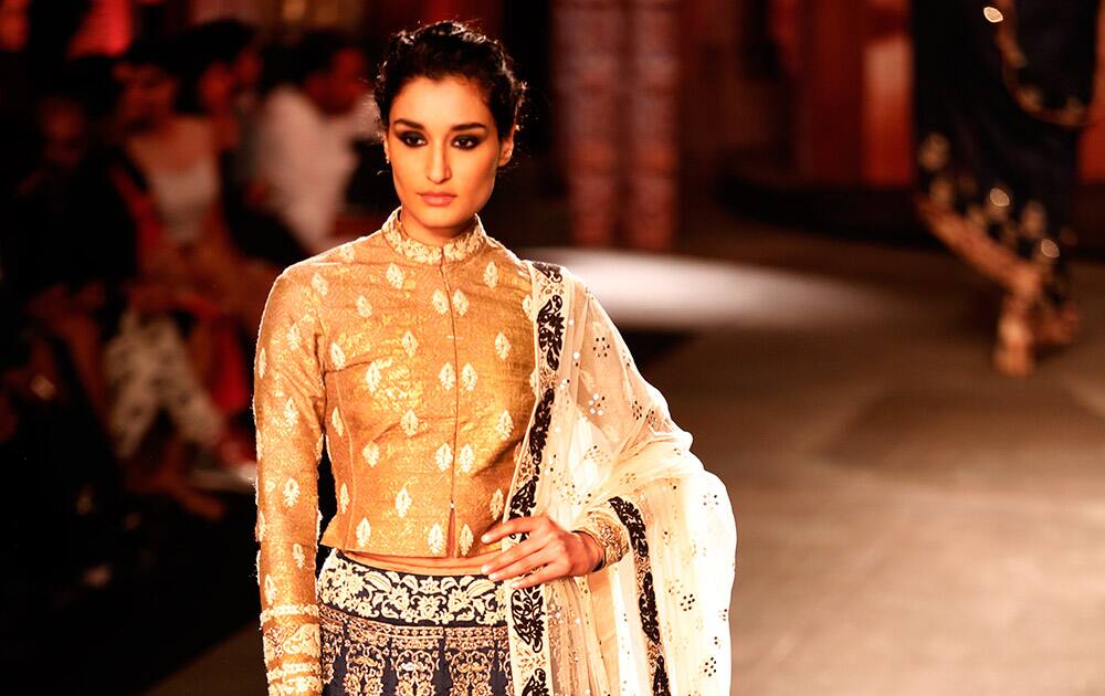 A model displays a dress created by Indian designer Anju Modi at the India Couture Week, held by Fashion Design Council of India, in New Delhi.