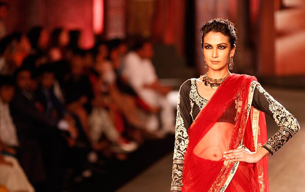 A model displays a sari created by Indian designer Anju Modi at the India Couture Week, held by Fashion Design Council of India, in New Delhi.