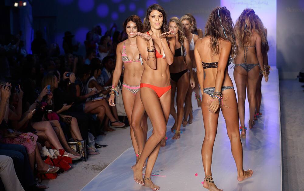 Models walk down the runway wearing swimwear designed by Frankie's Bikinis during the Mercedes-Benz Fashion Week Swim show in Miami Beach, Fla.