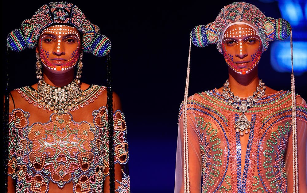 Models display dresses created by Indian designer Manish Arora at the India Couture Week, held by the Fashion Design Council of India, in New Delhi.