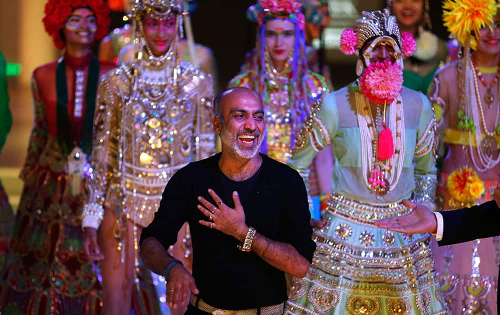 Indian designer Manish Arora laughs as he is introduced at the end of a fashion show displaying dresses designed by him at the India Couture Week, held by Fashion Design Council of India, in New Delhi.