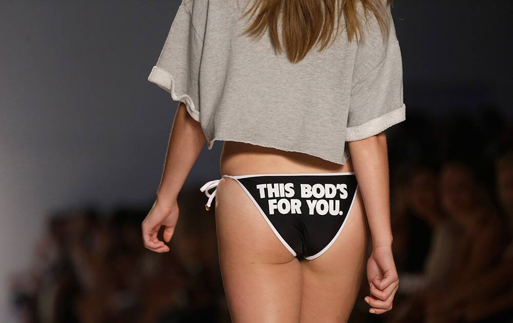 A model walks down the runway wearing swimwear designed by Wildfox during the Mercedes-Benz Fashion Week Swim show in Miami Beach, Fla.