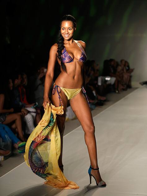 A model walks down the runway wearing swimwear designed by We Are Handsome during the Mercedes-Benz Fashion Week Swim show in Miami Beach, Fla.