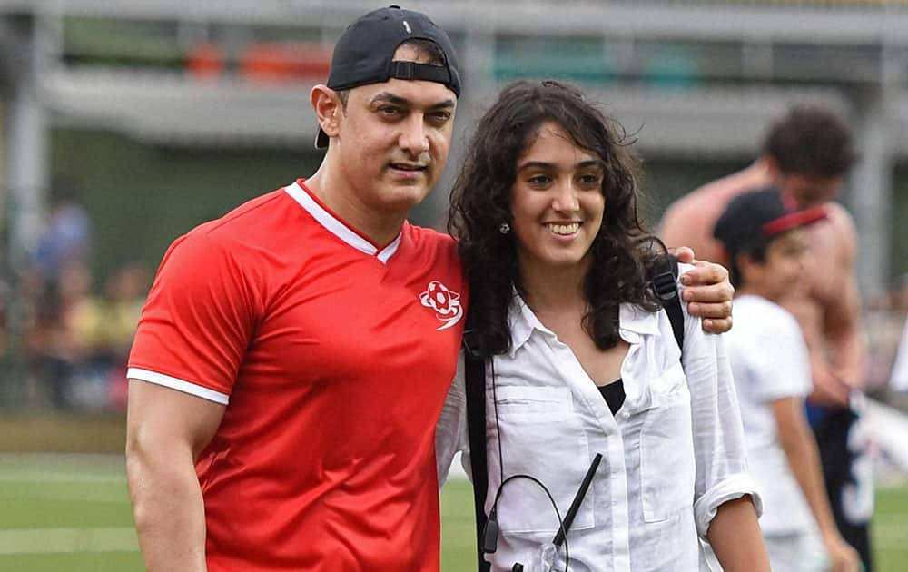 Bollywood actor Amir Khan along with his daughter Ira during a charity football match in Mumbai.