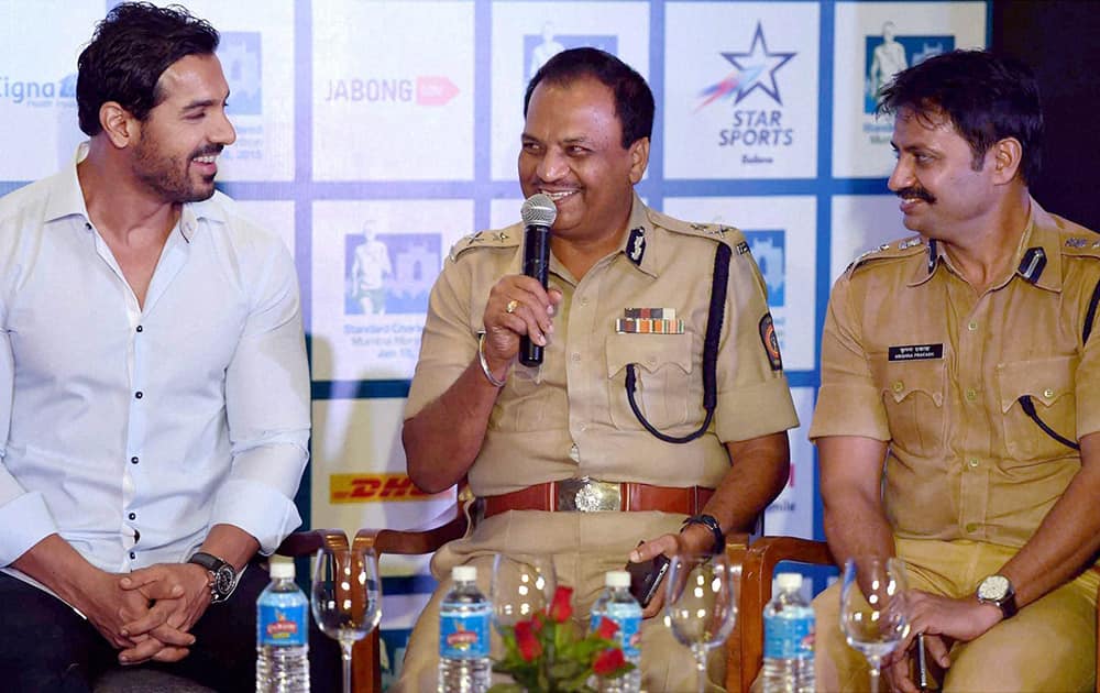 Bollywood actor John Abraham along with Joint Commissioner of Police (Traffic) B K Upadhyay and Additional Commissioner of Police Krishna Prakash during the launch of registrations of the 12 edition of Standard Chartered marathon 2015 in Mumbai.