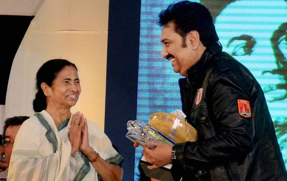 West Bengal chief minister Mamata Banerjee giving an award to singer Kumar Sanu at a ceremony organised on the 34th death anniversary of actor Uttam Kumar in Kolkata.