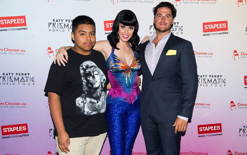 Global pop star Katy Perry, center, and local teacher and student from JHS 88 Peter Rougeet, left to right, Alex Martinez and Michael Seymour meet backstage at the Barclays Center during her Prismatic World Tour performance in Brooklyn, N.Y. 