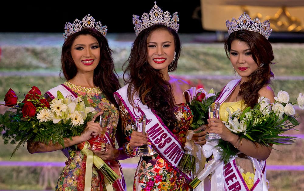 Winner of Miss Universe Myanmar 2014 Sharr Htut Eaindra, center, first runner up Yoon Mhi Mhi Kyaw, left, and second runner up Shwe Sin Ko Ko, right, pose for pictures during a pageant in Yangon, Myanmar.